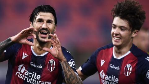 Bologna's Roberto Soriano and Aaron Hickey celebrate against Parma