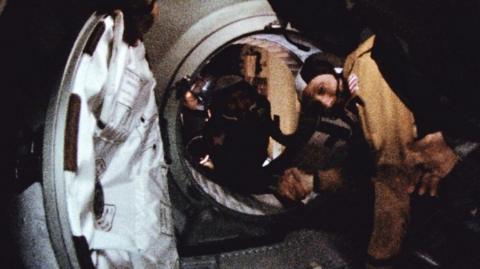 Astronaut Thomas Stafford and cosmonaut Aleksei Leonov make their historic handshake in space