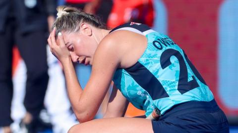 Lily Owsley of England crouched down with her head in her hands 