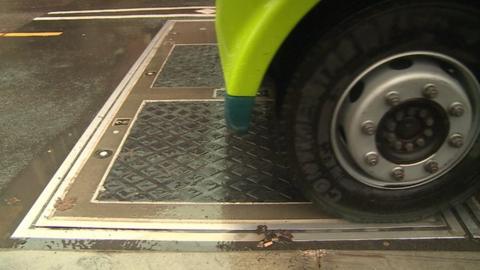 The bus recharges wirelessly over plates buried in the road