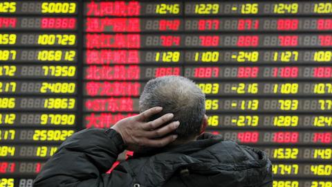 Man looks at stock markets in Asia