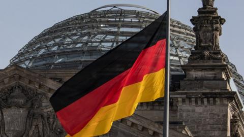 The German flag flies outside the Reichstag, the building which houses the Bundestag (the German lower house of parliament) on February 24, 2021 in Berlin