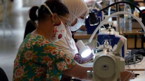 Workers inside a face masks factory in Roubaix, near Lille, as part of the visit of French Prime Minister Jean Castex on 3 August 2020 in Lille, France.