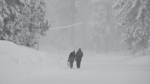 People walk in the snow in Sierra Nevada