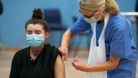 young woman having jab