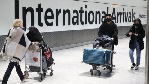 Passengers arrive at Heathrow Airport in London after the last British Airways flight from China touched down in the UK on Wednesday 29 January, 2020.