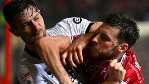 Joe Williams of Bristol City (left) and Ryan Leonard of Millwall clash during the match on 1 January