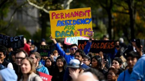 People take part in a pro-immigration rally in New York City on 26 October 2019.