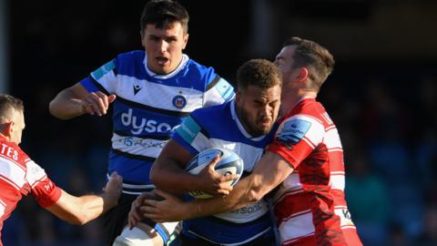 Bath debutant Ollie Lawrence is tackled by Gloucester centre Mark Atkinson