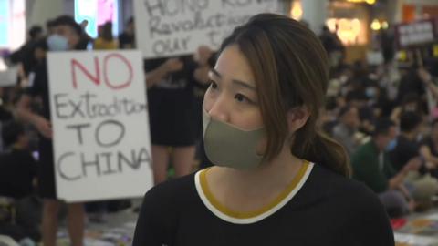 Airline worker explains why she's protesting at the airport in Hong Kong
