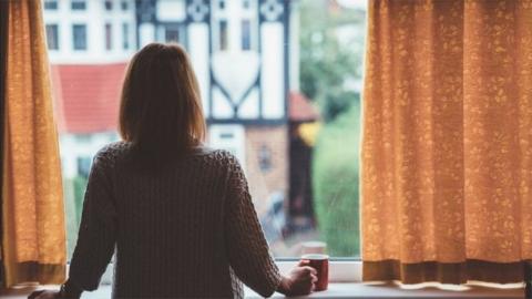 Woman alone at window