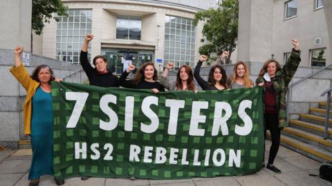 Seven women outside Milton Keynes Magistrates' Court with banner