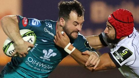 Ryan Conbeer of Scarlets is tackled by Akaki Tabutsadze of Black Lions