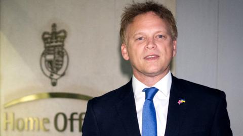 Grant Shapps speaks to the media outside the Home Office in London on 19 October