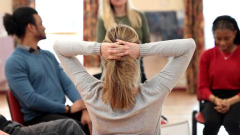 stock image of a victims' support group