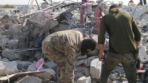 Two men stand amid rubble at scene of building destroyed by US after killing of Abu Bakr al-Baghdadi in Idlib province (27/10/19)