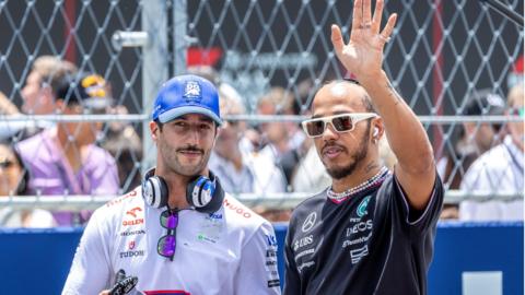 Lewis Hamilton waves to the crowd while stood alongside Daniel Ricciardo before the Miami Grand Prix