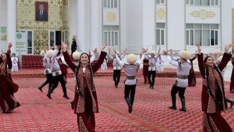 Folk artists perform in front of a polling station during the presidential election in Ashgabat on March 12, 2022