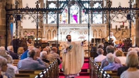 Father Lee Taylor address his congregation