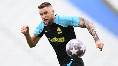 Milan Skriniar keeps his eye on the ball while playing for Inter Milan