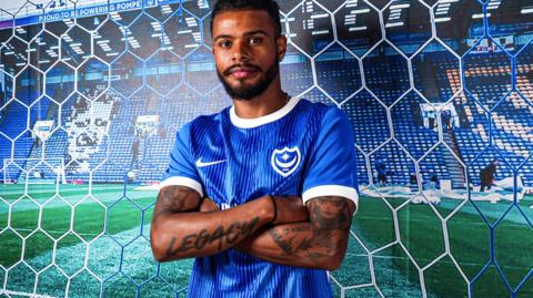 Tino Anjorin poses in his new Portsmouth colours as he joins on season-long-loan.