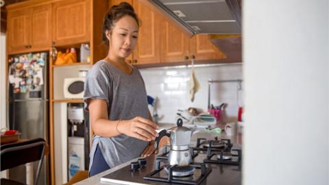 Woman making an espresso on a gas hob