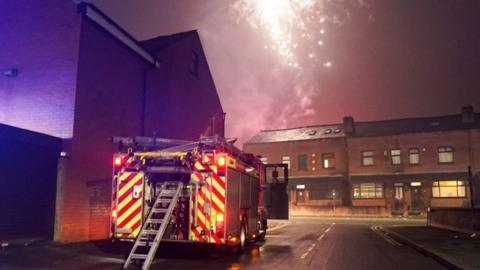 fire engine with firework going off in sky