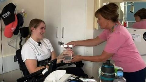 Georgia Carmichael receiving award from Lorraine Kelly