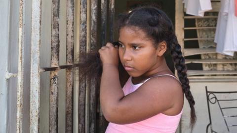 Cataleya Larrinaga Guerra (9) stands in the doorway of her grandparents home