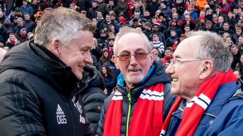 Ole Gunnar Solskjaer greets older mascots