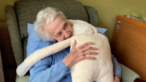 Hug doll with care home resident