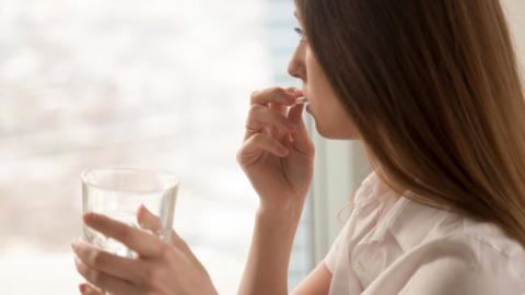 Women taking a pill