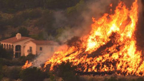 Undated photo obtained from the Santa Barbara County Fire, shows flames from the Thomas Fire near homes