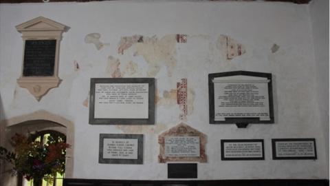 The fragments of wall painting, separated by later memorials