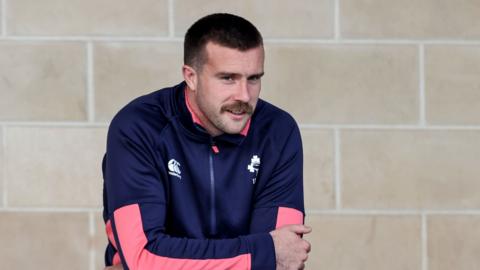 Mack Hansen watches Ireland training from the sidelines