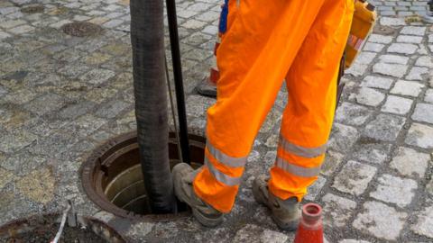 A sewerage worker on the street