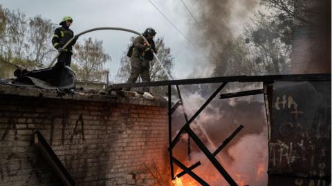 Image shows firefighters in Kharkiv