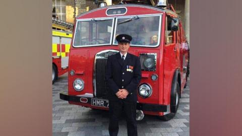 Mark Hillier in front of a fire truck