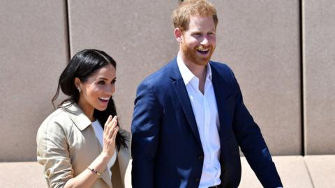 The Duchess and Duke of Sussex smiling for the cameras