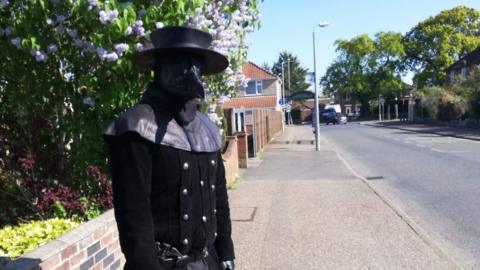 Person dressed as plague doctor