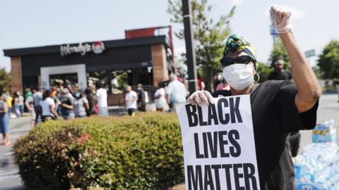 Protesters gather outside the Wendy's restaurant