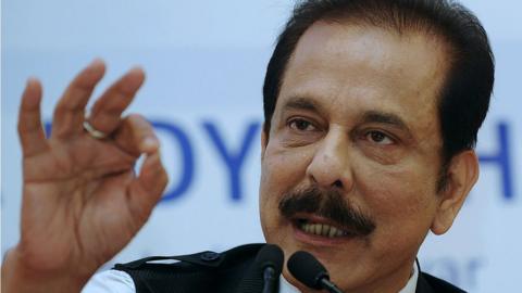 Chairman of India's Sahara Group Subrata Roy gestures as he addresses a press conference in Kolkata on November 29, 2013. An Indian regulator froze the bank accounts of two companies of the giant Sahara group in February 2013, after it failed to obey a court order to repay billions of dollars illegally collected from investors. Sahara, a household name in India and sponsor of the national cricket team, raised 240 billion rupees ($4.4 billion) in illegal bond sales to 30 million small investors between 2008 and 2011. AFP PHOTO/Dibyangshu SARKAR (Photo credit should read DIBYANGSHU SARKAR/AFP via Getty Images)
