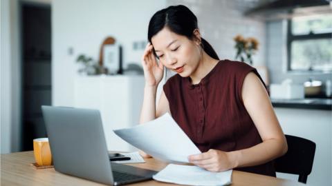 Woman looking at bill