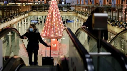 Commuter wears face covering in train station