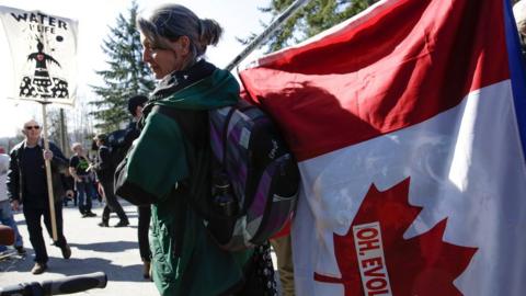 A woman protests against the expansion of Texas-based Kinder Morgan's Trans Mountain pipeline