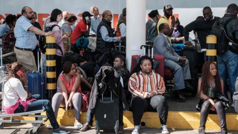 Passengers are blocked from entering Kenya Airways's departure terminal due to a strike by the airline workers at the Jomo Kenyatta International Airport in Nairobi on March 6, 2019