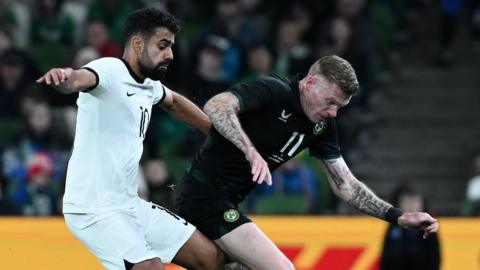 James McClean battles for the ball with Singh