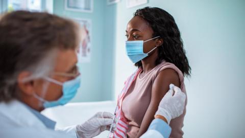 A woman getting a vaccine