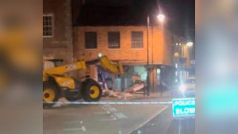 Digger outside Nationwide, Whittlesey