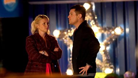 Matthew Horne and Joanna Page film in front of a giant illuminated Christmas star